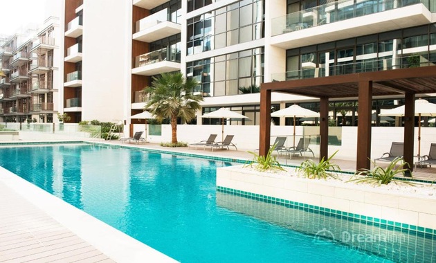 a swimming pool with palm trees and umbrellas