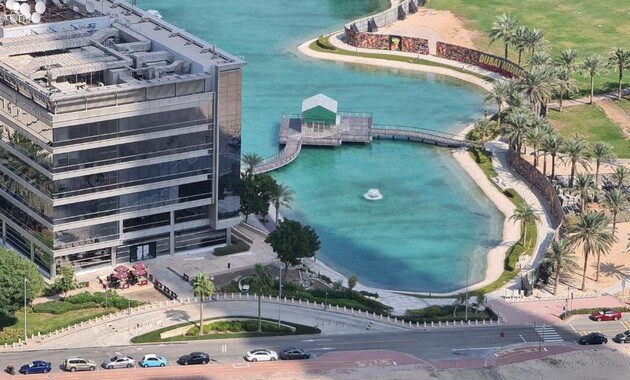 a water body with a bridge and a building