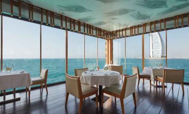 a sea facing restaurant with amazing view of skyline 