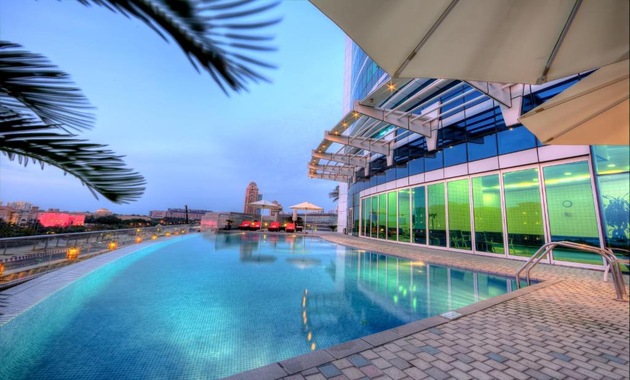 a pool with a building in the background