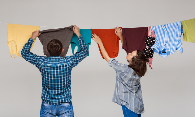 a girl and a boy is air drying clothes 