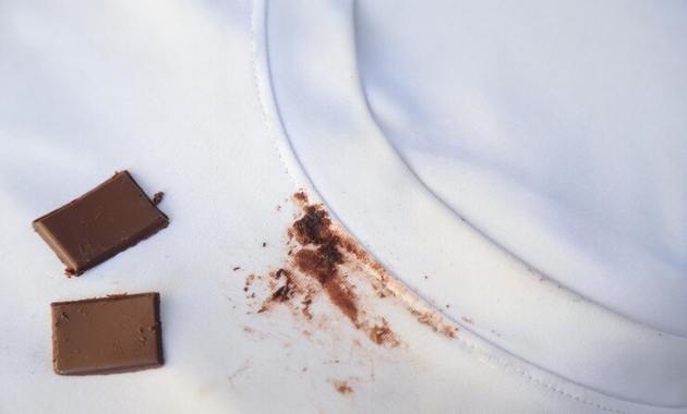 a white dirty shirt with melted chocolate stains