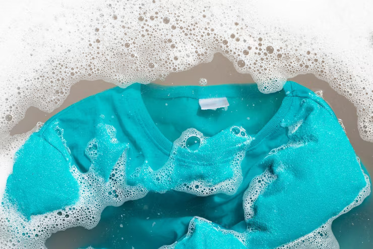 a blue shirt soaked in soapy water