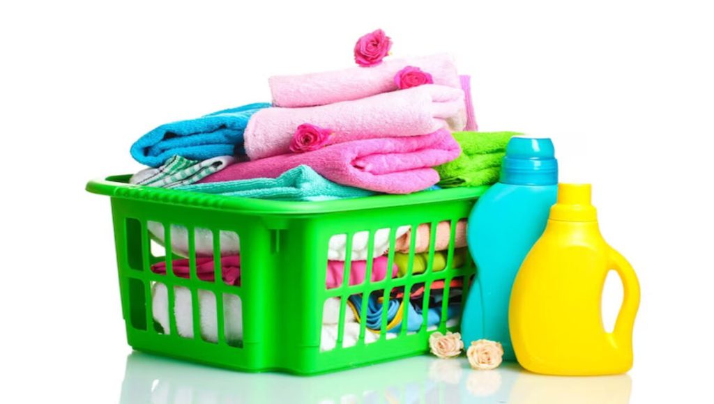 bottle of laundry detergent with a basket full of clothes