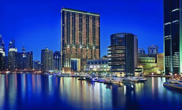 a city skyline with boats on water