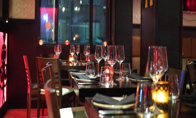 a table with wine glasses and candles