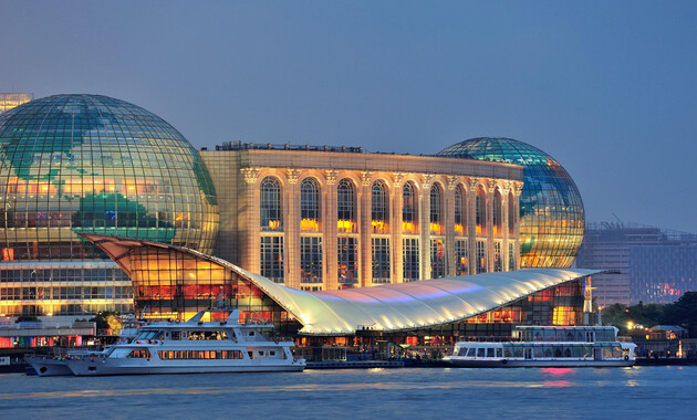 Dubai's best museum building with glass domes and a boat on the water