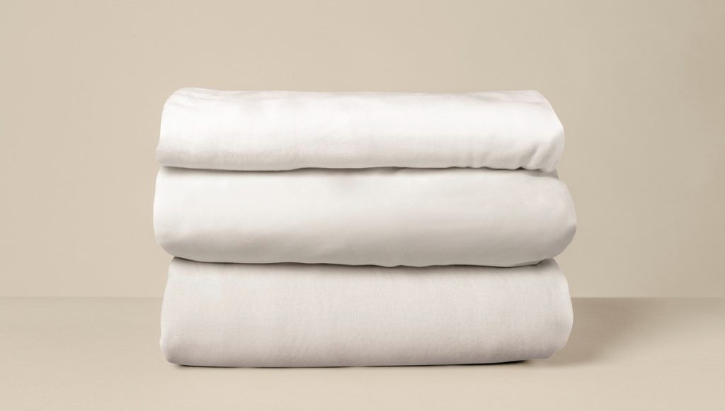 3 folded white bed linens