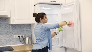 a lady cleaning refrigerator