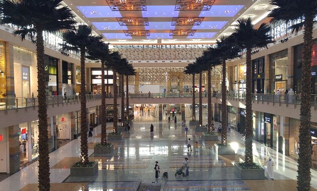 a large building with palm trees