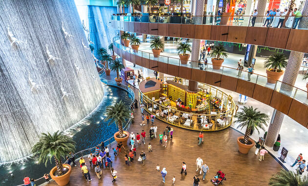 dubai mall with a waterfall and people