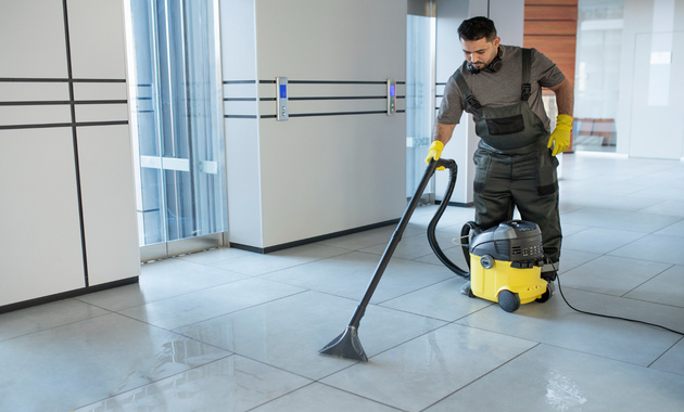 a man is vacuuming tile floors with vacuum cleaner