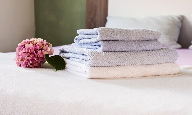 white towels placed over white bed sheets