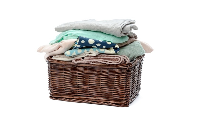 wooden laundry basket filled with clothes 