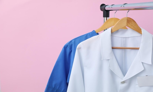 white coat and blue shirt hanging on a hanging stand