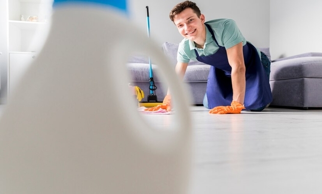 a man a cleanin the bedroom floor