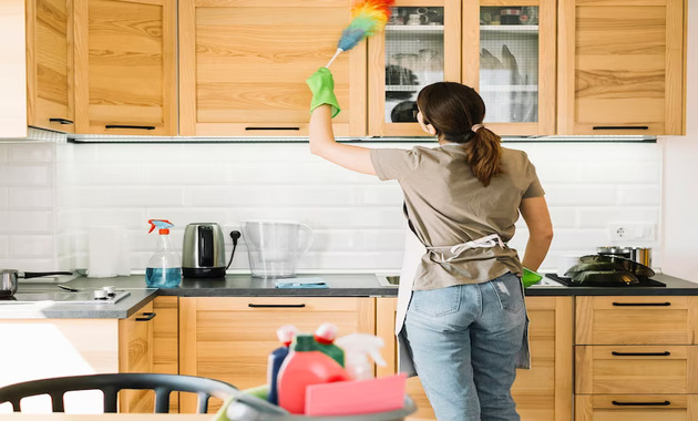 women cleaning kitchen cabinets